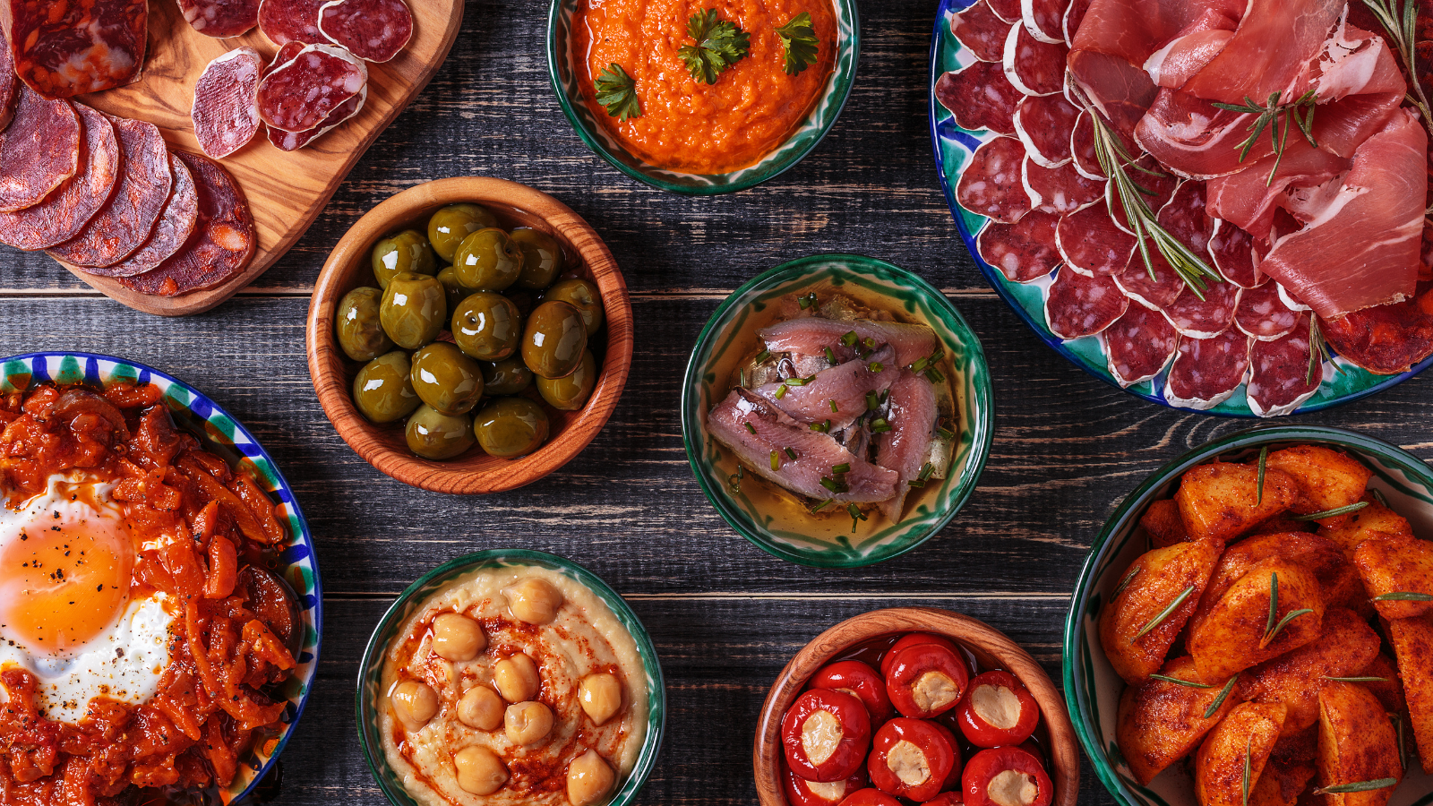A typical selection of Spanish tapas showing olives, Jamón, chorizo, etc.